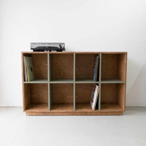 Front View of Plywood Vinyl Storage in Olive Division in Cognac Outer Color with Stack of Vinyl Records