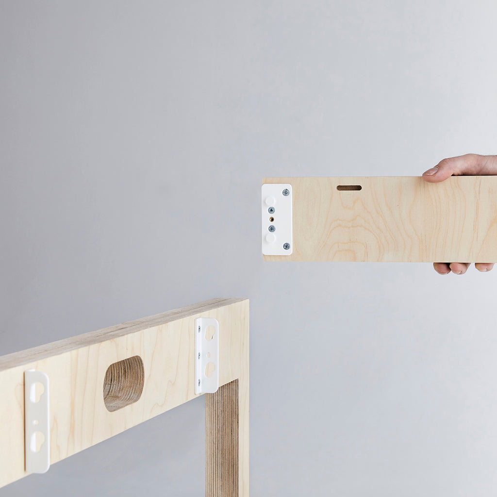 Hand Holding a Wooden Panel from a Disassembled Table