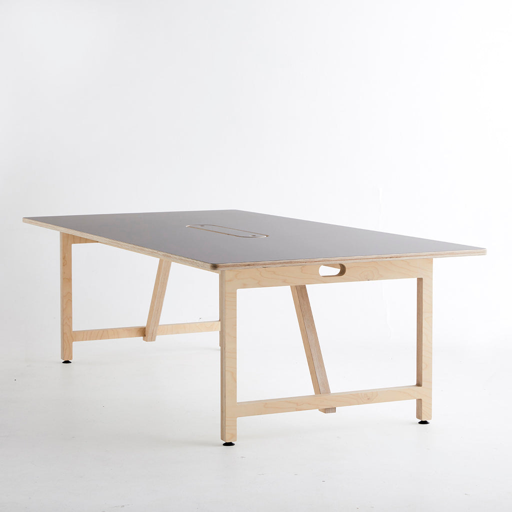 Side View of a Team Table with Ultra Matt Finish Surface and Plywood Base