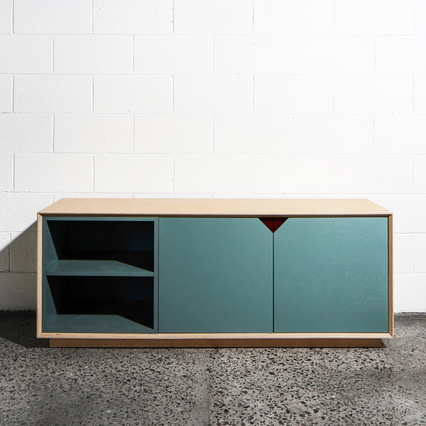 Plywood media unit in a room with a white wall