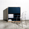 Front View of Plywood Fold Out Storage Desk in Navy Blue with an Acrylic Chair and File Organizers