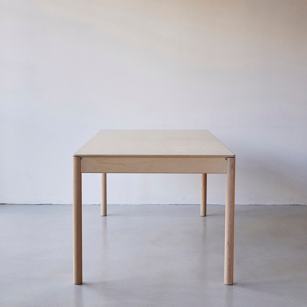Side View of a Minimalist Natural Coloured Wooden Dining Table 