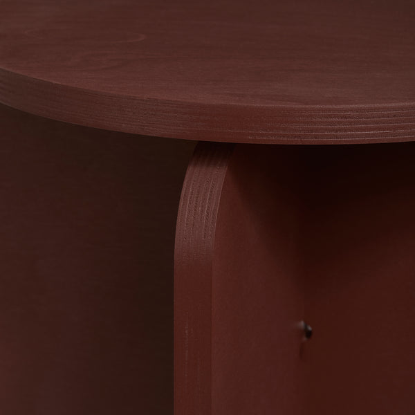 Close-up of modern plywood stool in crimson color