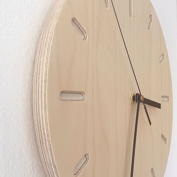Side-view of a round timber plywood wall clock