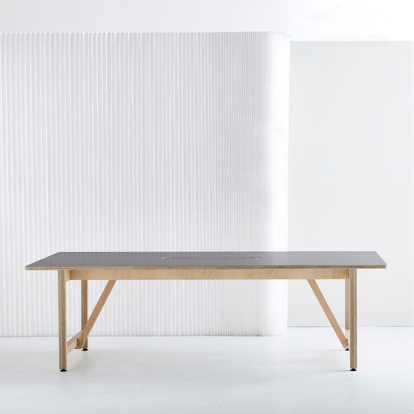 Side View of a Long Team Table with Ultra Matt Finish and Plywood Base in a White Painted Room
